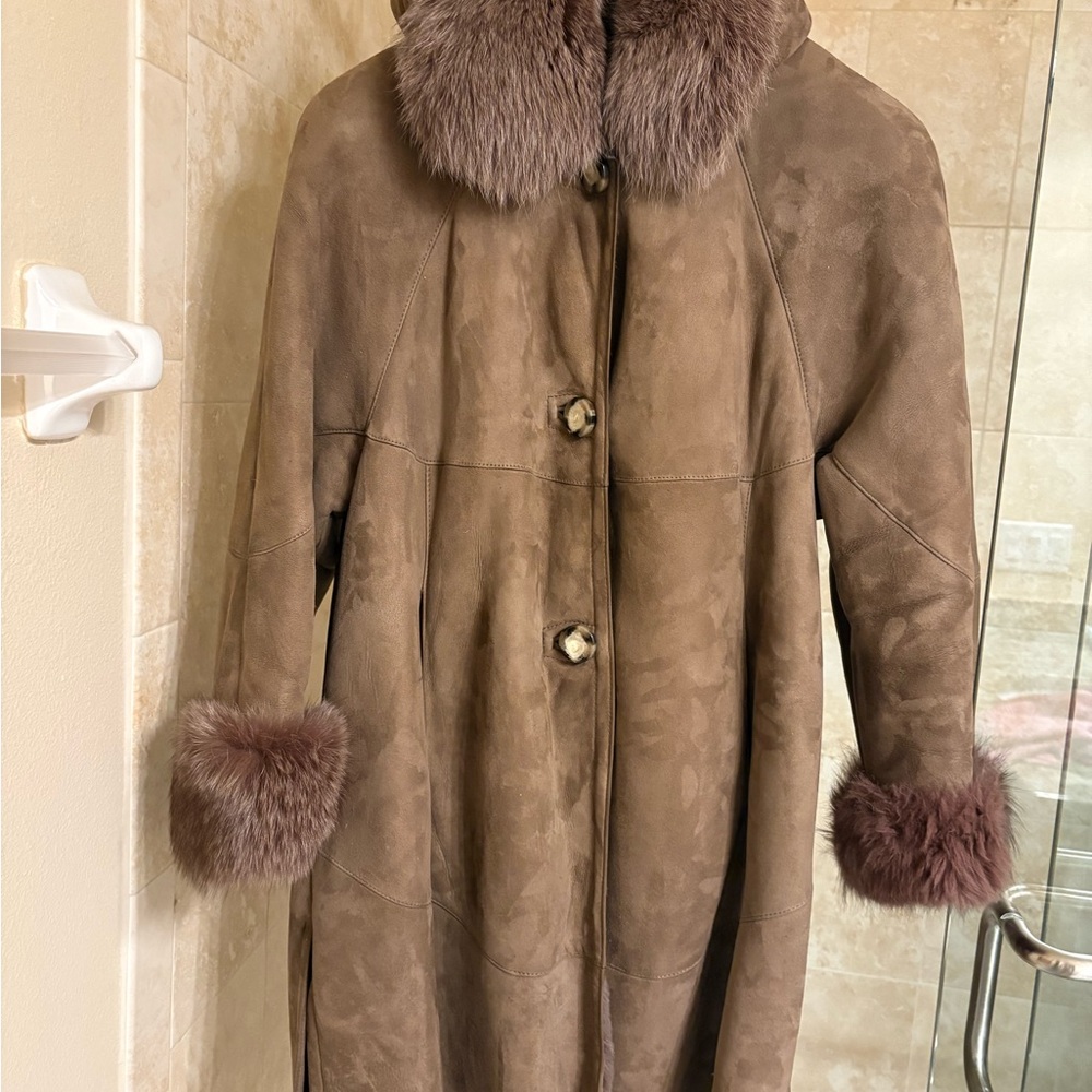 Luxurious genuine shearling coat with genuine Fox collar, cuffs, removable hood.